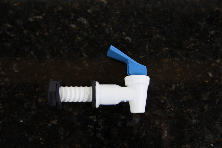 White plastic tap with blue flick tap handle